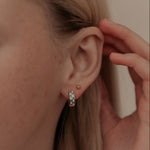 Load image into Gallery viewer, Close-up of a person wearing a small hoop earring and sunshine flat back stud with a hand adjusting it.
