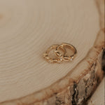 Load image into Gallery viewer, Gold earrings on a wooden surface
