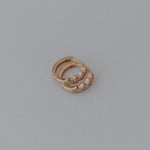 Load image into Gallery viewer, Gold star earrings with a small stone on a gray background
