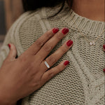 Load image into Gallery viewer, Person wearing a beige knitted sweater with a close-up of their hand and ring.
