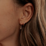 Load image into Gallery viewer, Close-up of an ear wearing a small earring with a blurred background
