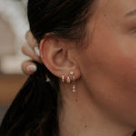Load image into Gallery viewer, Close-up of a person wearing earrings with a blurred background
