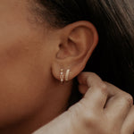 Load image into Gallery viewer, Close-up of an ear wearing a gold hoop earring with a blurred background
