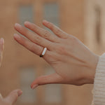 Load image into Gallery viewer, Close-up of two hands with a ring, blurred background
