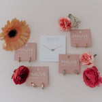 Load image into Gallery viewer, Jewelry display with necklaces on pink cards against a white background
