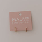 Pink jewelry card with 'MAUVE JEWELRY CO' on a light gray background featuring diamond and gold hoop earrings