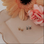 Pair of earrings on a decorative plate with flowers