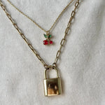 Load image into Gallery viewer, Necklace with a padlock charm and red berries on a white background
